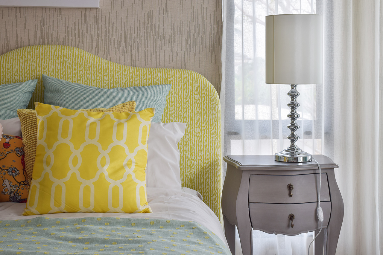 pattern-pillows-on-classic-style-bed-and-reading-lamp-